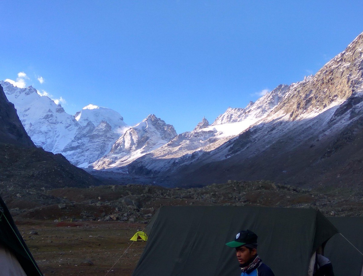 Tents at a riverside camp on the Hampta Pass trail
